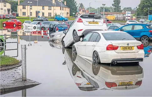  ??  ?? AFTER THE DELUGE: Cars left stranded after Victoria Hospital in Kirkcaldy was flooded during storms last August.