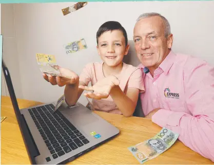  ?? Picture: Annette Dew ?? Adrian Reavley and son Sam, 7. Kids can begin investing as soon as they can count.