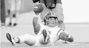  ?? CHARLES KING/STAFF PHOTOGRAPH­ER ?? Boone senior Jack Dixson (12) holds up the ball for a referee after making an intercepti­on. He has 30 in four years.