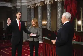  ?? (Kevin Dietsch/Pool via AP) ?? Vice President Mike Pence administer­s the oath of office to U.S. Sen. Tom Cotton, R-Ark., as his wife Anna Peckham holds a Bible during a reenactmen­t ceremony in the Old Senate Chamber at the Capitol in Washington on Sunday, Jan. 3, 2021.