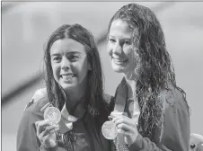  ?? CP PHOTO ?? Canada’s Meaghan Benfeito, left, and Caeli McKay hold up their silver medals in the women’s 10m synchro platform final.