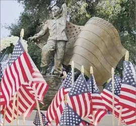  ?? Francine Orr Los Angeles Times ?? THE ENDURING Heroes Memorial honors 10 men and one woman from Pasadena and nearby towns. The statue’s face has features from each of the 11 fallen.