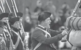  ?? ?? Lt. William Tidd, portrayed by Barry Cunha, yells to the British “you’ll not get my gun!” on Lexington Green in Massachuse­tts. Patriots’ Day commemorat­es the battles of Lexington and Concord.