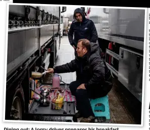  ??  ?? Dining out: A lorry driver prepares his breakfast