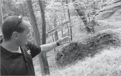  ?? Jason Nark/Philadelph­ia Inquirer/TNS ?? ■ Kem Parada of Finders Keepers points Monday to a rock where he and his father had dug in Elk County, believing a lost shipment of Civil War gold is buried in the area.