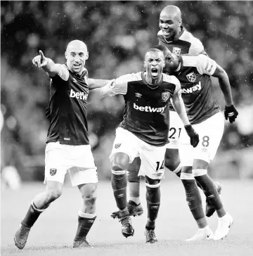  ??  ?? West Ham United’s Pedro Obiang (second left) celebrates scoring their first goal with Pablo Zabaleta and teammates during the English Premier League match against Tottenham Hotspur at Wembley Stadium in London, Britain. — Reuters photo