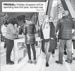  ?? Sipa USA ?? FRUGAL: Holiday shoppers will be spending less this year, surveys say.