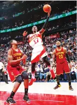  ??  ?? TENSE MOMENT: Dennis Schroder (17) of the Atlanta Hawks attacks the basket against Tristan Thompson (13) and LeBron James (23) of the Cleveland Cavaliers at Philips Arena in Atlanta, Georgia, on Friday. (AFP)