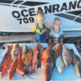  ??  ?? Xavier Williams (left) and brother Archie show off their dad’s midweek reef catch of trout and emperor.