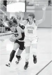  ?? [SARAH PHIPPS/ THE OKLAHOMAN] ?? Norman's Kelbie Washington, left, tries to get past Edmond North's Toni Papahronis during a game on Jan. 17 at Edmond North.