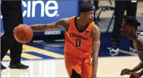  ?? (AP/Kathleeen Batten) ?? Oklahoma State’s Avery Anderson III scored a career-high 31 points during the No. 17 Cowboys’ victory over No. 6 West Virginia on Saturday in Morgantown, W.Va.