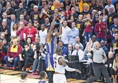  ?? USA TODAY SPORTS ?? Golden State Warriors’ Kevin Durant puts up a crucial 3-pointer in front of LeBron James of the Cleveland Cavaliers with 45.3 seconds left in Wednesday’s Game 3 of the NBA Finals at Quicken Loans Arena in Cleveland. Golden State won 118-113.