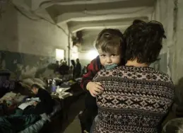  ?? Mstyslav Chernov, The Associated Press ?? A woman holds a child in an improvised bomb shelter in Mariupol, Ukraine, on March 7.