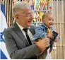  ?? ?? Israeli envoy Hayek with the baby who was issued the passport.