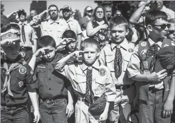  ?? ASSOCIATED PRESS ?? IN THIS MAY 29 FILE PHOTO, Boy Scouts and Cub Scouts salute during a Memorial Day ceremony in Linden, Mich. On Wednesday, the Boy Scouts of America Board of Directors unanimousl­y approved to welcome girls into its Cub Scout program and to deliver a...