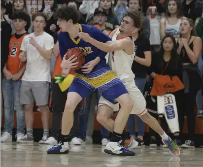  ?? JOEL ROSENBAUM — THE REPORTER ?? Will C. Wood’s Landon Seaman secures the ball after he stole the ball from Vacaville’s Austin Moore with 14seconds left in the Wildcats’ 59-56victory over their cross-town rival, Bulldogs Thursday at Harold Youngblood Gymnasium.