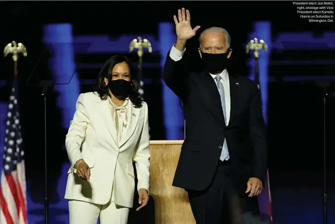  ??  ?? President-elect Joe Biden, right, onstage with Vice President-elect Kamala Harris on Saturday in
Wilmington, Del.