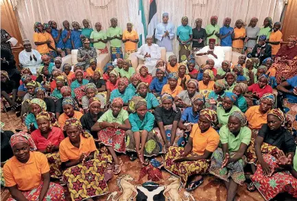  ?? PHOTO: REUTERS ?? Nigeria’s President Muhammadu Buhari applauds as he welcomes a group of Chibok girls, who were held captive for three years by the millitant group Boko Haram, in Abuja, Nigeria.