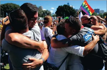  ?? PICTURE: REUTERS ?? People celebrate after it was announced the majority of Australian­s support same-sex marriage in a survey, paving the way for legislatio­n for the country to formalise the unions by the end of the year, at a rally in Sydney, Australia, today.