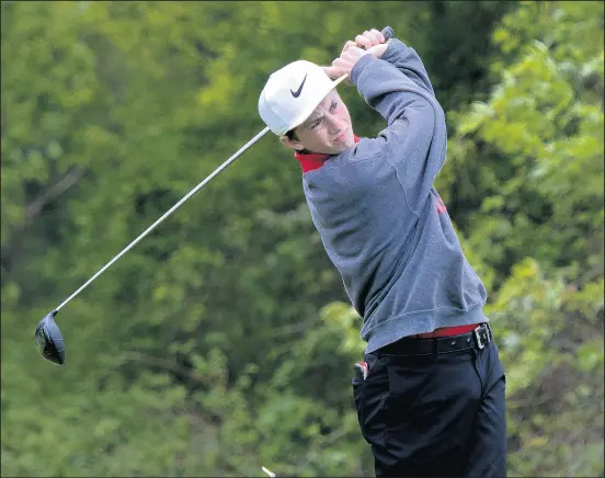  ?? MICHAEL GARD/POST-TRIBUNE PHOTOS ?? Crown Point’s Finn Kiger tees off during the Duneland Athletic Conference meet at Brassie Golf Club in Chesterton.