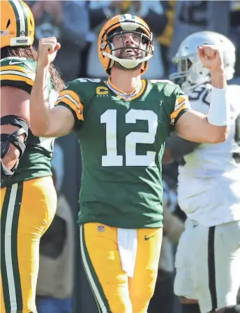  ?? MARK HOFFMAN / JOURNAL SENTINEL ?? Packers quarterbac­k Aaron Rodgers celebrates his touchdown pass to tight end Jimmy Graham during the third quarter Sunday.