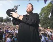  ?? Donall Farmer / Associated Press ?? Shane Lowry celebrates with the Claret Jug after winning the British Open during a homecoming event in Clara in County Offaly, Ireland on Tuesday.