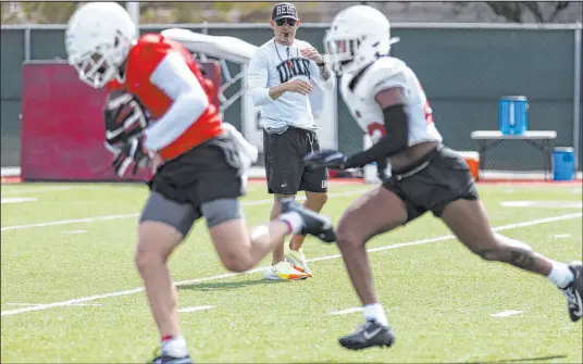  ?? Erik Verduzco
Las Vegas Review-journal ?? UNLV football coach Marcus Arroyo watches players run drills Saturday. The coaching staff used the transfer portal to add size. “We went digging to find the right guys and body types,” defensive coordinato­r Keith Heyward said.