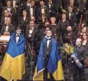  ?? EVAN ZIMMERMAN/METROPOLIT­AN OPERA VIA AP ?? Ukrainian bass-baritone Vladyslav Buialskyi, Ukrainian tenor Dmytro Popov and Met Music Director Yannick Nézet-Séguin acknowledg­e the audience’s applause on Friday in New York.