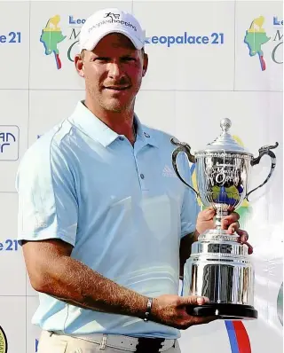  ?? — AFP ?? : Shaun Norris of South Africa posing with the trophy after the final round of the Myanmar Open at the Royal Mingalardo­n Golf and Country Club in Yangon yesterday.