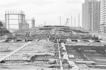  ??  ?? Workers lay out steel bars in constructi­ng the eight-kilometer four-lane elevated highway along Buendia avenue in Makati City, metro Manila, Philippine­s. While the peso’s dip is raising eyebrows in a region where the Thai baht and the Malaysian ringgit...