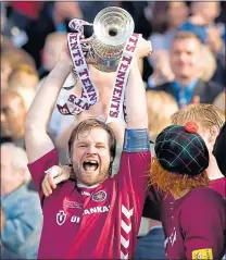  ??  ?? Steven Pressley lifts the Scottish Cup for Hearts in 2006