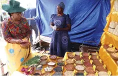  ?? ?? Agric4She patron First Lady Dr Auxillia Mnangagwa looks at various types of traditiona­l crop seeds produced by women under the Agric4She programme in Mashonalan­d East