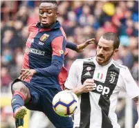  ??  ?? Genoa’s Cristian Kouame competes for the ball with Juventus defender Bonucci yesterday. Genoa won 2-0