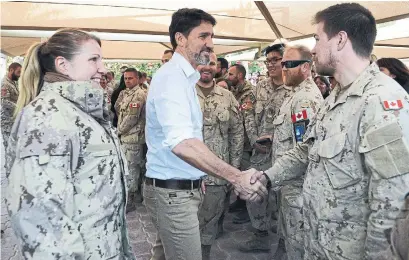  ?? SEAN KILPATRICK THE CANADIAN PRESS ?? Prime Minister Justin Trudeau visits with troops at “Camp Canada” at Ali Al-salem Air Base in Kuwait on Monday.