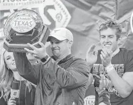  ?? Elizabeth Conley / Houston Chronicle ?? Tom Herman’s first season at Texas got off to a rocky start with a home loss to Maryland but culminated with the Longhorns’ coach hoisting a trophy after the Longhorns beat Missouri in the Academy Sports + Outdoors Texas Bowl.