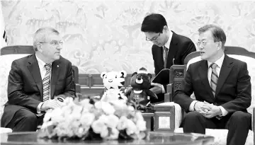  ??  ?? South Korean President Moon Jae-in (R) speaks with Internatio­nal Olympic Committee President Thomas Bach during a meeting at the presidenti­al Blue House in Seoul on July 3, 2017. -AFP photo