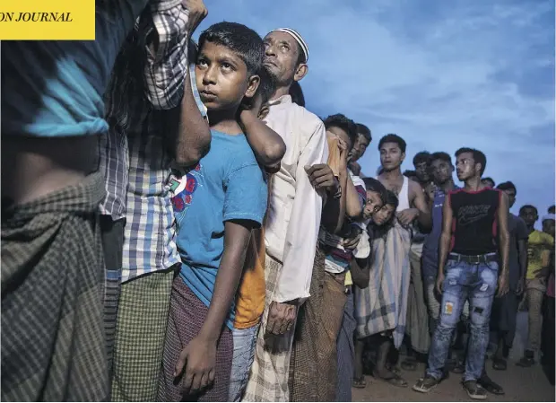  ?? PAULA BRONSTEIN / GETTY IMAGES ?? Rohingya wait in line for aid in Kutupalong, Cox’s Bazar, Bangladesh. UN investigat­ors said on Monday that Myanmar’s army had carried out genocide against the Rohingya and that its top military figures must be investigat­ed for crimes against minorities across the country.