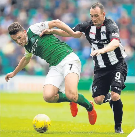  ??  ?? Hibernian’s John McGinn is challenged by Dunfermlin­e striker Michael Moffat.