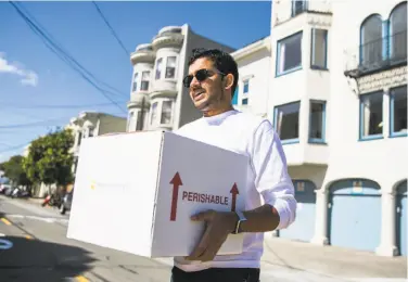  ?? Mason Trinca / Special to The Chronicle ?? Movebutter CEO Chai Mishra delivers a box to a customer in San Francisco. Mishra said he often delivers directly to his customers so he can receive feedback about the company.