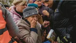  ?? BERNAT ARMANGUE/AP ?? An elderly woman reacts after receiving food donations Thursday from World Central Kitchen in Kherson, a port city liberated earlier this month in southern Ukraine.