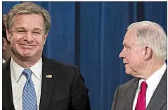  ?? AP/ALEX BRANDON ?? FBI agents replace a tarp Friday that fell off the van involved in the mailbomb investigat­ion as the vehicle was being transporte­d from Plantation, Fla. In the photo at left, FBI Director Christophe­r Wray (left) chats with Attorney General Jeff Sessions before a news conference Friday at the Department of Justice in Washington.