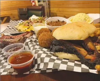  ?? Sally Carroll/Special to the Weekly Vista ?? Bubba’s Hillbilly BBQ co-owner Dawn Miller’s sliced brisket, “bombs” (her version of a popper), nachos and ribs are tasty dishes that rank high on the popularity list. People come from as far away as Kansas City for the barbecue, she said.