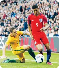  ??  ?? Marcus Rashford leaves Australia’s Josh Risdon chasing shadows on his England debut in May last year.