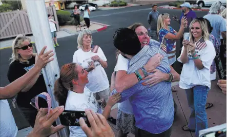  ?? Chase Stevens ?? Las Vegas Review-journal @csstevensp­hoto Eric Parker is embraced by Ashley, who declined to give her last name, after he and three other defendants in the Bunkervill­e standoff case were released Tuesday from the Henderson Detention Center following the...