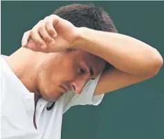  ??  ?? Tomic reacts against Zverev during their men’s singles first round match on the second day of the Wimbledon Championsh­ips at The All England Lawn Tennis Club in Wimbledon, southwest London. — AFP photo