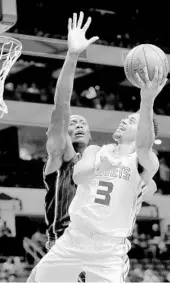  ?? STREETER LECKA/GETTY IMAGES ?? Orlando’s Bismack Biyombo, back, tries to block the shot of Charlotte’s Jeremy Lamb Monday night in Charlotte.