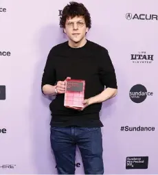  ?? — AFP photo ?? Eisenberg holds the Waldo Salt Screenwrit­ing Award for the film A Real Pain during the 2024 Sundance Film Festival Awards at The Ray.