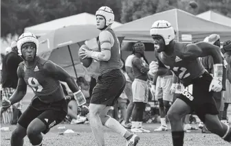  ?? Jerry Baker / Contributo­r ?? Klein Cain quarterbac­k Luke Pardee, center, and his teammates don soft-shell helmets Friday for their Division I bracket game against Anderson at the state 7-on-7 tournament in College Station.