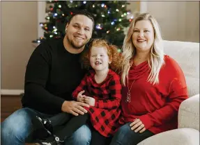  ?? JADE WARE VIA AP ?? Nick Jones, left, poses with his wife Mindy Jones and their daughter Gracelyn Jones at their home in Louisville, Ky. The Jones family are among a growing number of people who have gone full-on Christmas weeks early. Usually Mindy waits until the Saturday after Thanksgivi­ng to jump start the holiday.