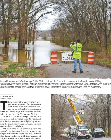  ?? STAFF PHOTOS BY DOUG STRICKLAND ?? Kenny Kinnaman with Chattanoog­a Public Works photograph­s floodwater­s covering Aster Road in Lookout Valley on Wednesday after heavy rainfall. Continuous rain through the week has raised area waterways to flood stages, with more rain expected in the coming days. Below: EPB repairs power lines after a fallen tree closed Gadd Road on Wednesday.